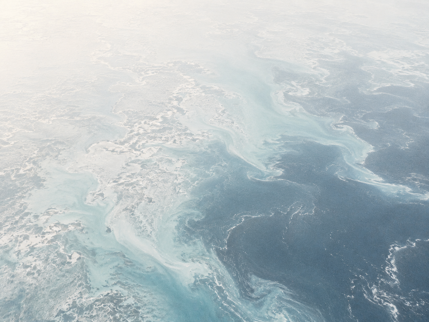 Aerial view of ice and turquoise water
